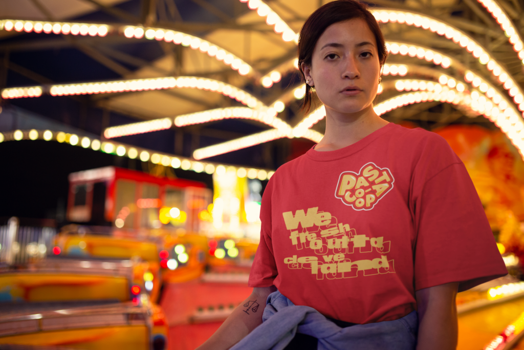 unisex-tee-mockup-featuring-a-serious-woman-in-front-of-a-carnival-ride-22982 (1)